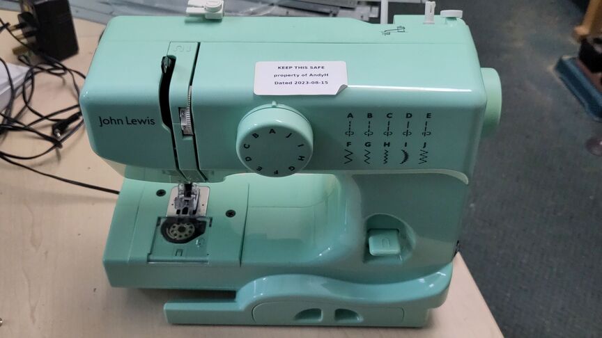 A small sky blue sewing machine.